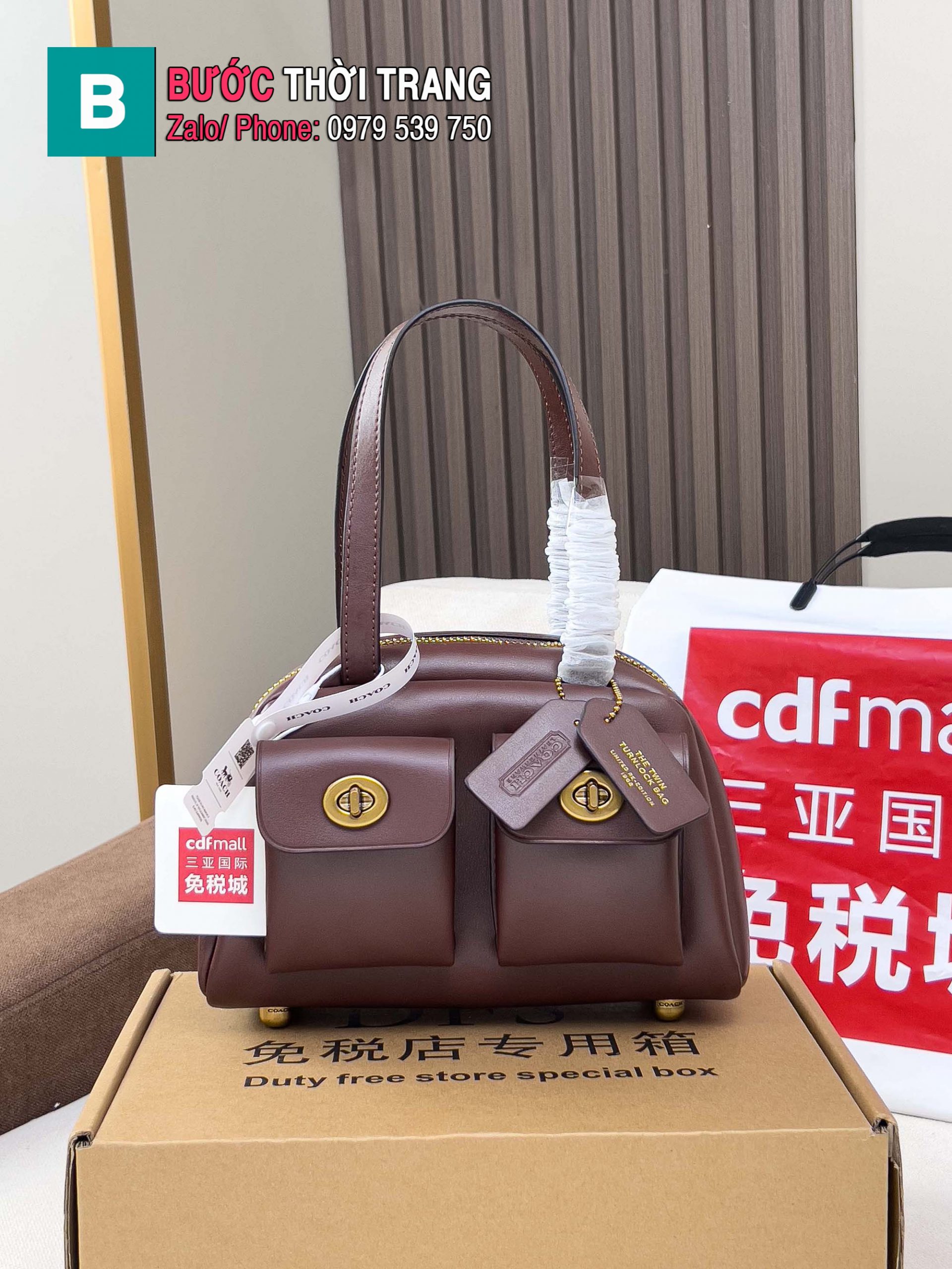 Túi Nữ Coach Twin Turnlock size 21x12x10 cm màu nâu socola khóa vàng